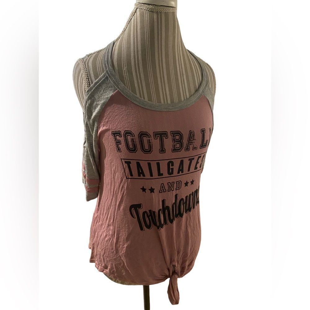 Super cute football tee shirt shoulders are cut out so cute brand is Rebellious